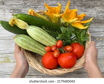 hand holding a basket of fresh vegetale