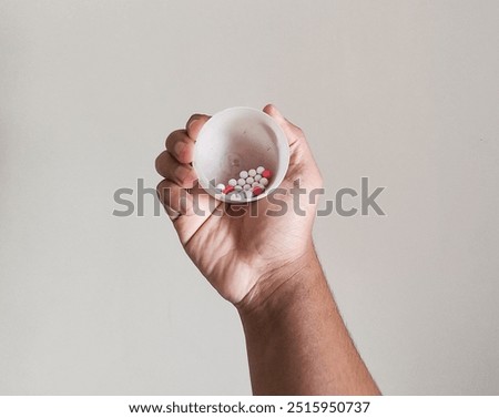 hand holding bb bullet for airsoft gun and air pistol toy