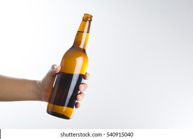 Hand Holding A Beer Bottle Without Label Isolated On White Background