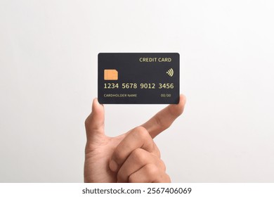 Hand holding black credit card isolated on white background.