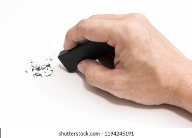 Hand holding black eraser scrap on paper background. 
Error Eraser dust on white background.
top view. - Powered by Shutterstock