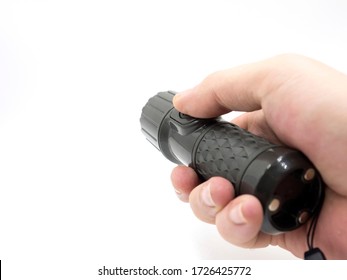 hand holding black flashlight isolate on white background