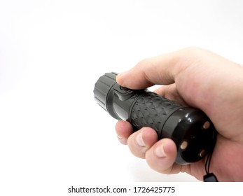 hand holding black flashlight isolate on white background