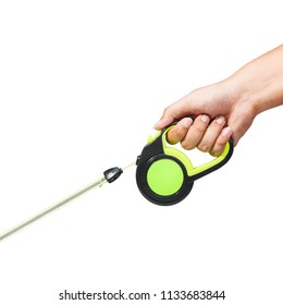 Hand Holding Black And Green Retractable Dog Leash On Isolated White Background