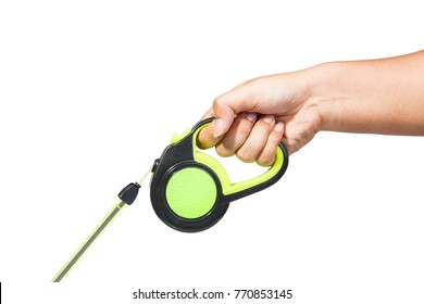 Hand Holding Black And Green Retractable Dog Leash On Isolated White Background