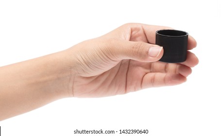 Hand Holding Black Plastic Bottle Cap Isolated On White Background