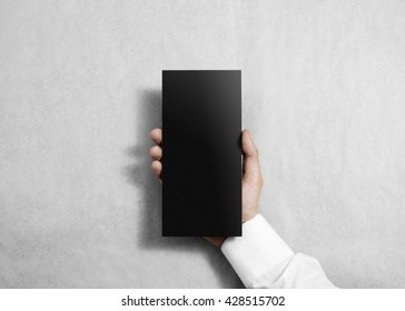 Hand Holding Blank Black Flyer Brochure Booklet. Leaflet Presentation. Pamphlet Hold Hands. Man Show Grey Offset Paper. Sheet Template. Booklet Design. Display Read First Person