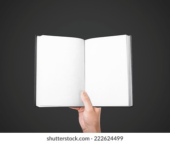 Hand Holding A Blank Book On A Black Background
