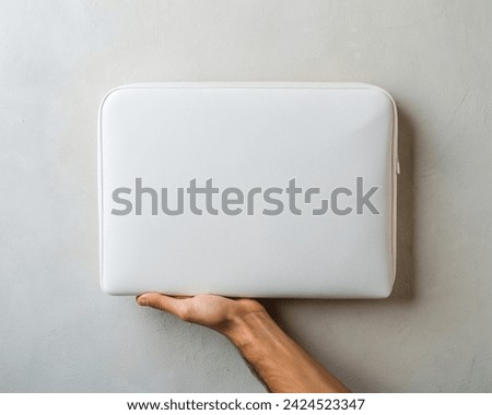 Hand holding a blank Laptop Sleeve Mockup. White leather Blank Laptop Case Mockup. Background Image. Laptop cover Mockup. Clean Minimalist 