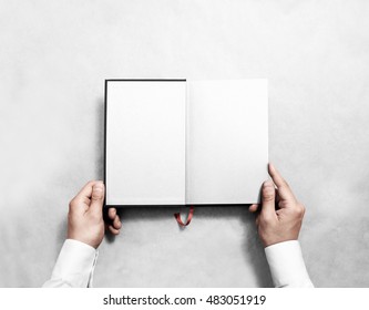 Hand Holding Blank Opened Book Mock Up With White Half Title. Person Reading Empty Paperback Mockup. Black Notebook Inside Template. Publication Design Leafing Man. Textbook Spread With Bookmark.