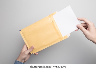 Hand Holding Blank Padded Envelope Mock-up, Ready To Replace Your Design.