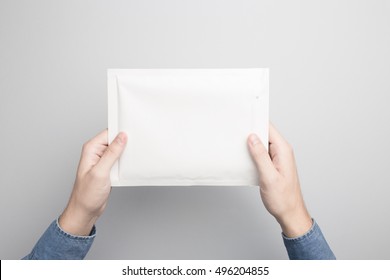 Hand Holding Blank Padded Envelope Mock-up, Ready To Replace Your Design.