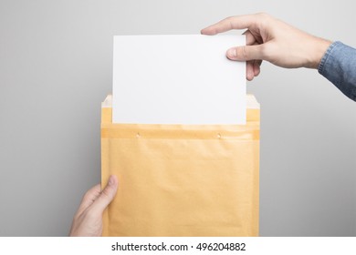Hand holding Blank padded Envelope Mock-up, ready to replace your design.