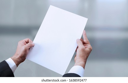 Hand Holding Blank Paper At Office