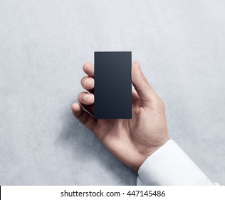Hand Holding Blank Vertical Black Business Card Design Mockup. Clear Calling Card Mock Up Template Hold Arm. Visit Pasteboard Paper Surface Display Front. Small Dark Offset Card Holder Presentation