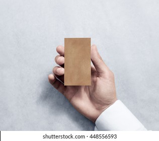 Hand Holding Blank Vertical Kraft Business Card Design Mockup. Clear Calling Card Mock Up Template, Craft Paper. Pasteboard Display Front. Small Offset Texture Card Print. Business Identity