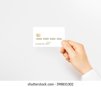 Hand Holding Blank White Credit Card Mockup Isolated. Empty Plastic Card Mock Up Hold In Arm. Clear Surface Bank Card With Gold Emboss Numbers. Debit Card Concept Design Presentation Golden Money Card