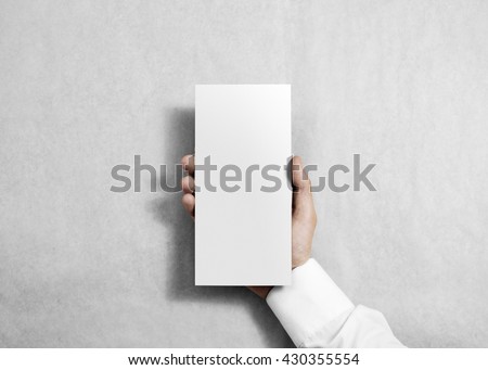 Hand holding blank white flyer brochure booklet. Leaflet presentation. Pamphlet hold hands. Man show clear offset paper. Sheet template. Booklet design sheet display read first person