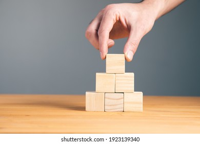 Hand holding blank wooden block cubes, business concept background.