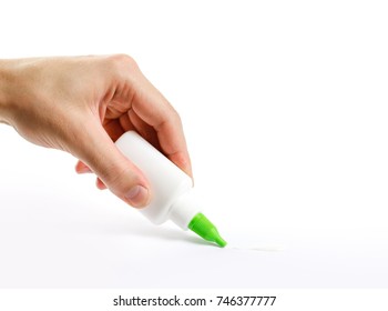 Hand Holding A Bottle Of Glue. Deals PVA Glue On Paper. Isolated On White Background.