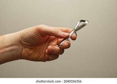 Hand Holding A Bottle Opener With Clean Background