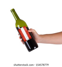 Hand Holding A Bottle Of Red Wine, Label Of Austria, Isolated On White,