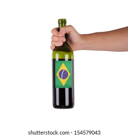 Hand Holding A Bottle Of Red Wine, Label Of Brazil, Isolated On White,