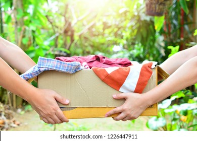 hand holding box give clothes together for concept donation and reuse recycle - Shutterstock ID 1226447911