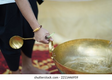 Hand Holding Brass Pan
Brass Wok, Cooking Utensils
Brass Wok And Wood Spoon On Gas Stove