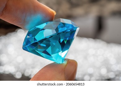 Hand Is Holding Brilliant Or Diamond Gem On Black Background.