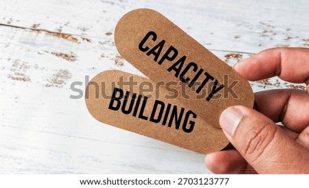 Hand Holding Brown Capsules with the Text 