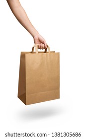 Hand Holding A Brown Paper Bag With Handle Isolated On White 