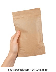 A hand holding a brown paper bag. Ziplock pouch, zip-lock packet isolated on white