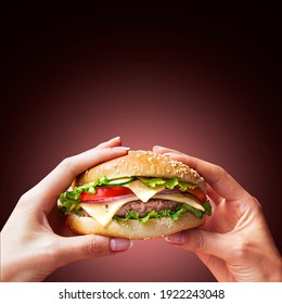 Hand Holding A Burger In A Darkbackground. Eating And Healthy Concept, Restaurant Food Concept.