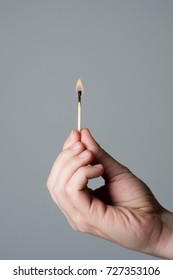 Hand Holding A Burning Matchstick