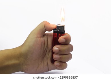 Hand holding burning a red color gas lighters isolated on white background. Gas lighter close up. Tool to used to create a flame - Powered by Shutterstock