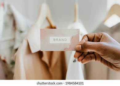 Hand holding business card at a boutique