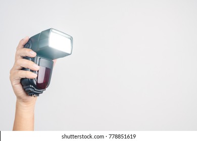 Hand Holding Camera  External Flash Speed Light On White Background