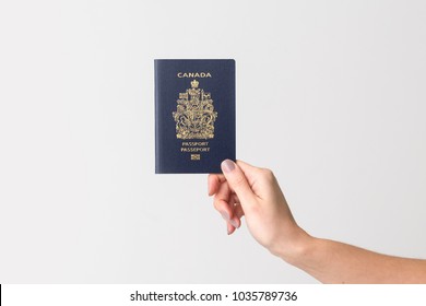 Hand Holding Canadian Passport.