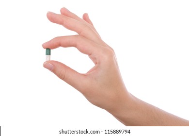 Hand Holding A Capsule Or Pill Isolated On White