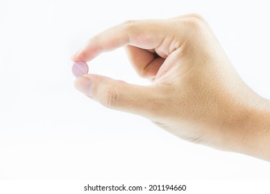 Hand Holding A Capsule Or Pill Isolated On White