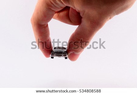 hand holding a car