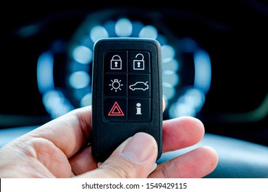 Hand Holding A Car Intelligent Keyless Remote.