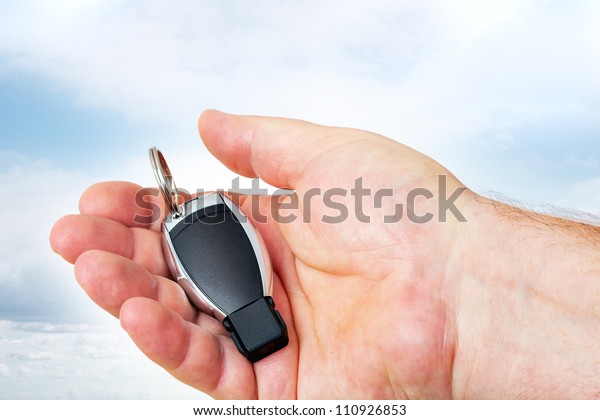 Hand holding car\
keys