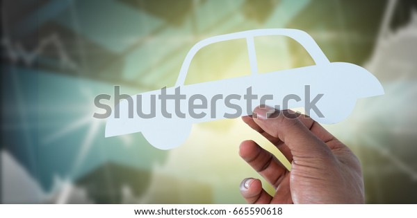 hand\
holding a car in paper against buildings with\
graphs