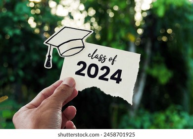 Hand holding a card with the words Class Of 2024 - Powered by Shutterstock