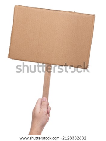 A Hand holding a cardboard sign without any captions from below using a stick.