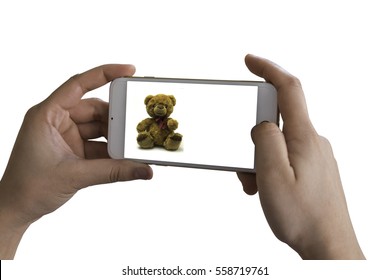 Hand Holding Cell Phone For Take Picture Concept On Teddy Bear Background