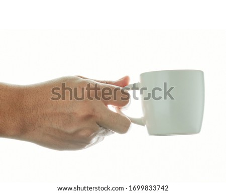 Hand holding a ceramic mug on white  background ,Men hand with perfect white cup