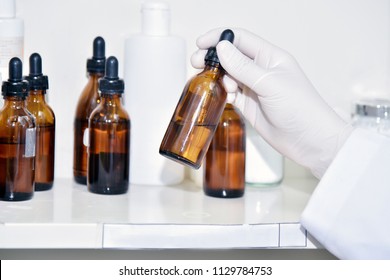 Hand holding chemical bottles in  laboratory